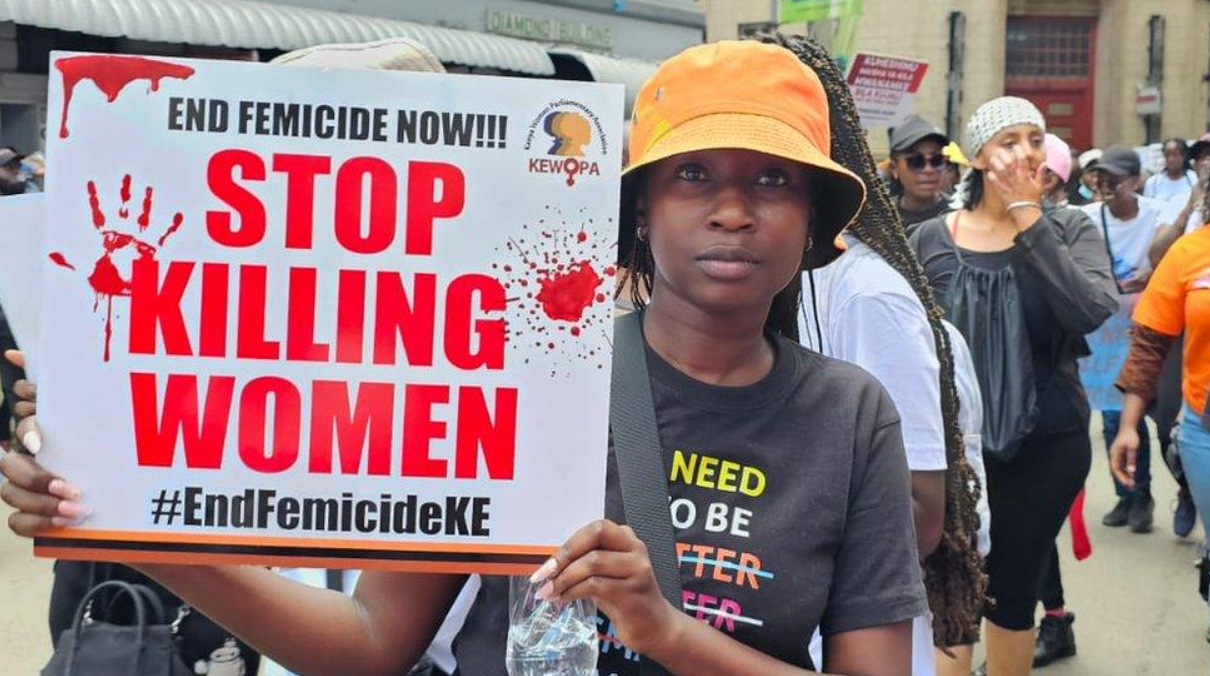 An image showing Protest against femicide in Kenya. A woman holds a sign demanding an end to violence against women.