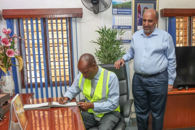 Trade Cabinet Secretary Lee Kinyanjui and Raju Chatthe at Kibos Sugar Factory during a site visit and assessment of industrial sugar production in August 2025.