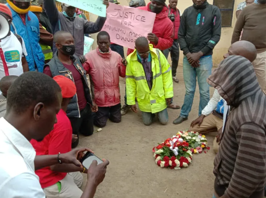 Protesters gather in prayer at the Kondele–Kibos road scene where Meshak Ouma (37), George Oudi (28), and Martin Bonyo (25) lost their lives after being struck by a vehicle linked to the Kibos Sugar company boss.