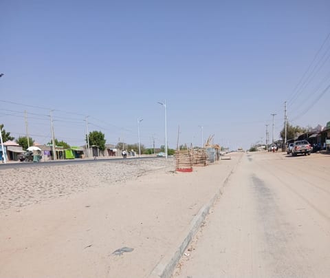 A tarmacked road covered in dirt in Lodwar town. No County services to remove this yet many youths stay unemployed and resort to alcoholism
