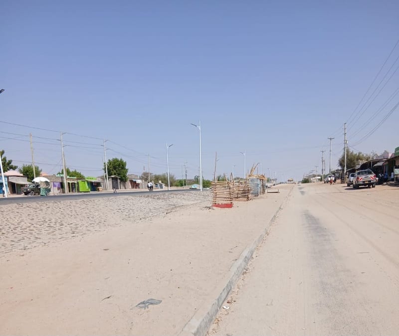 A tarmacked road covered in dirt in Lodwar town. No County services to remove this yet many youths stay unemployed and resort to alcoholism