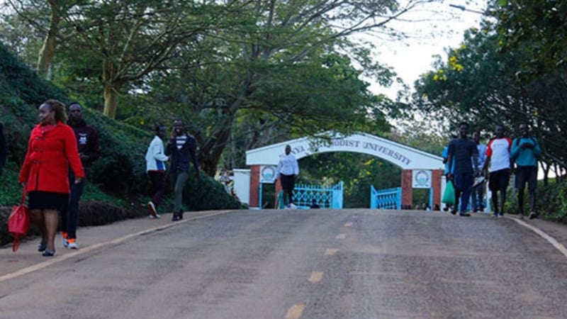 Students walking along the Kenya Methodist University entrance.