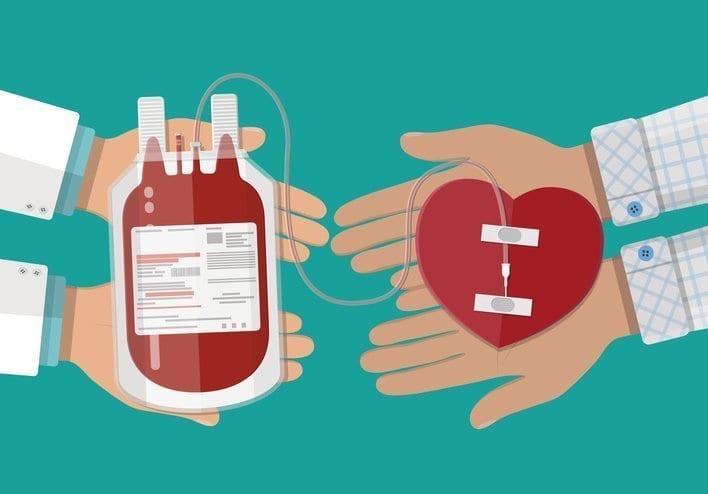 Blood bag and hand of donor with heart