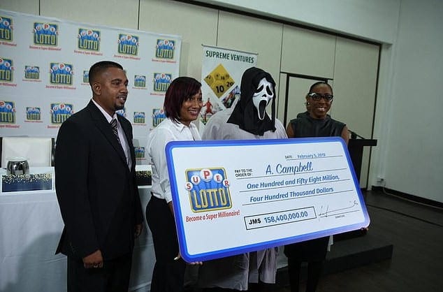 Photos: Jackpot winner appears in a mask to claim his prize