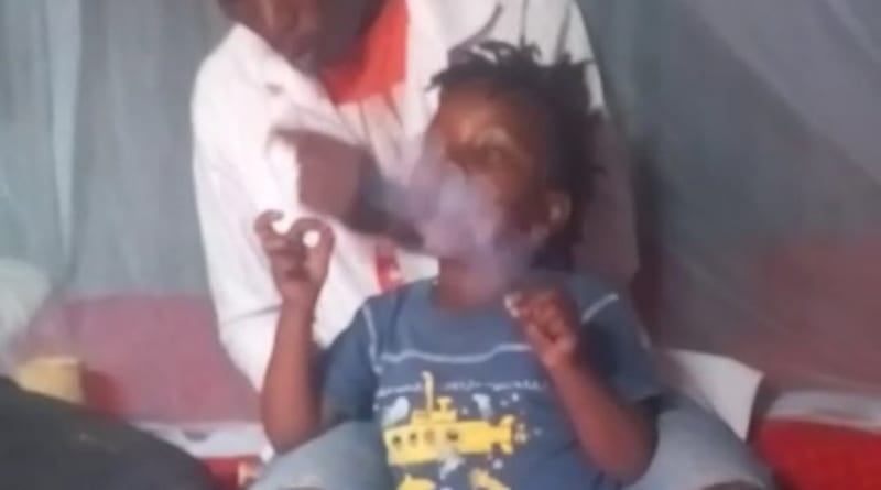 Social media erupts with rage after video of a child smoking marijuana under the watch of two adults goes viral