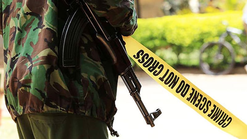 An armed police officer at a crime scene. FILE PHOTO