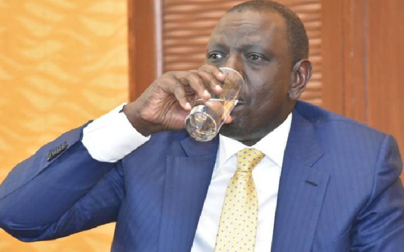 President William Ruto taking a sip of water